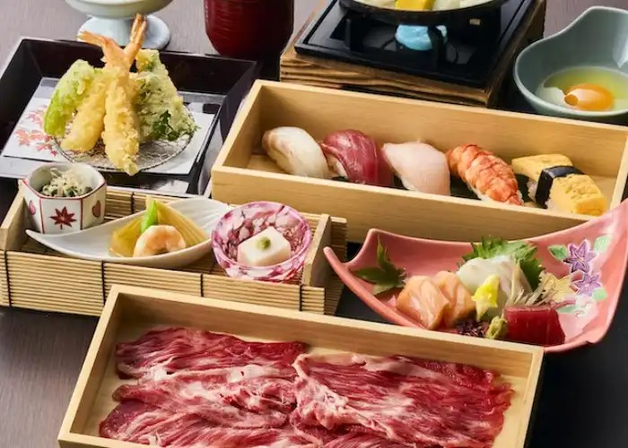 A premium kaiseki course at Ganko Takasegawa Nijoen, featuring meats, sushi, tempura, and many side dishes.